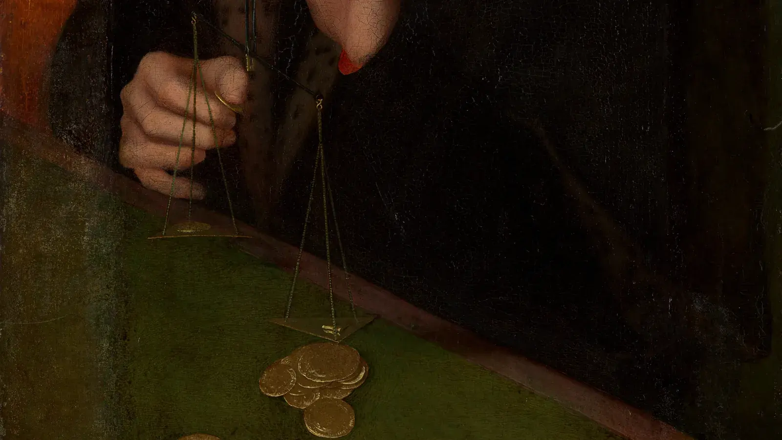 Detail of a sixteenth-century painting: a man's hand holding a small balance above a pile of gold coins on a green table